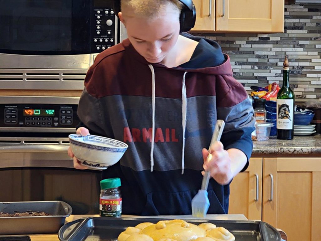 Siobhán adding butter to bread