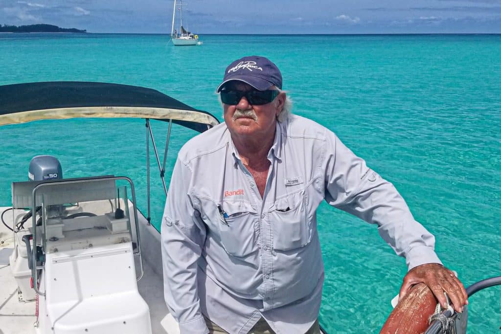 Bahamian pilot Bandit arrives in his skiff.