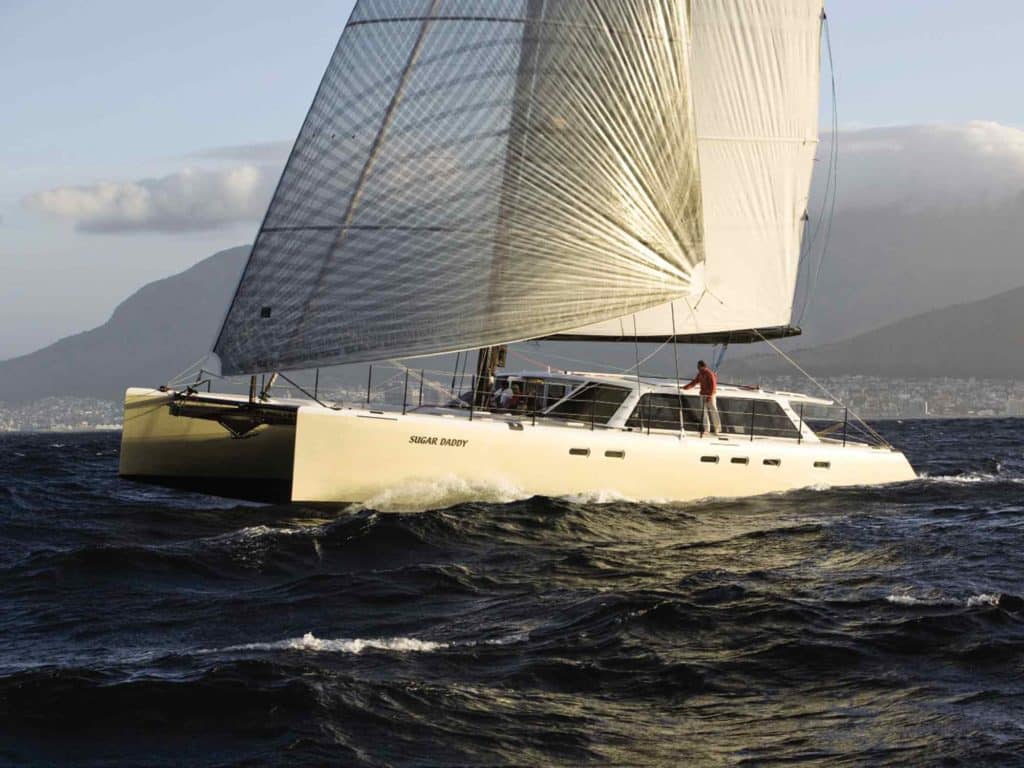 Catamaran sailing off Cape Town's Table Mountain