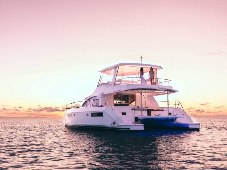 A charter boat on the water at sunset.