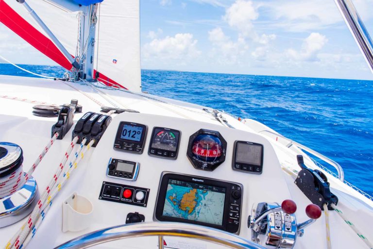 The helm and console of a sailboat.